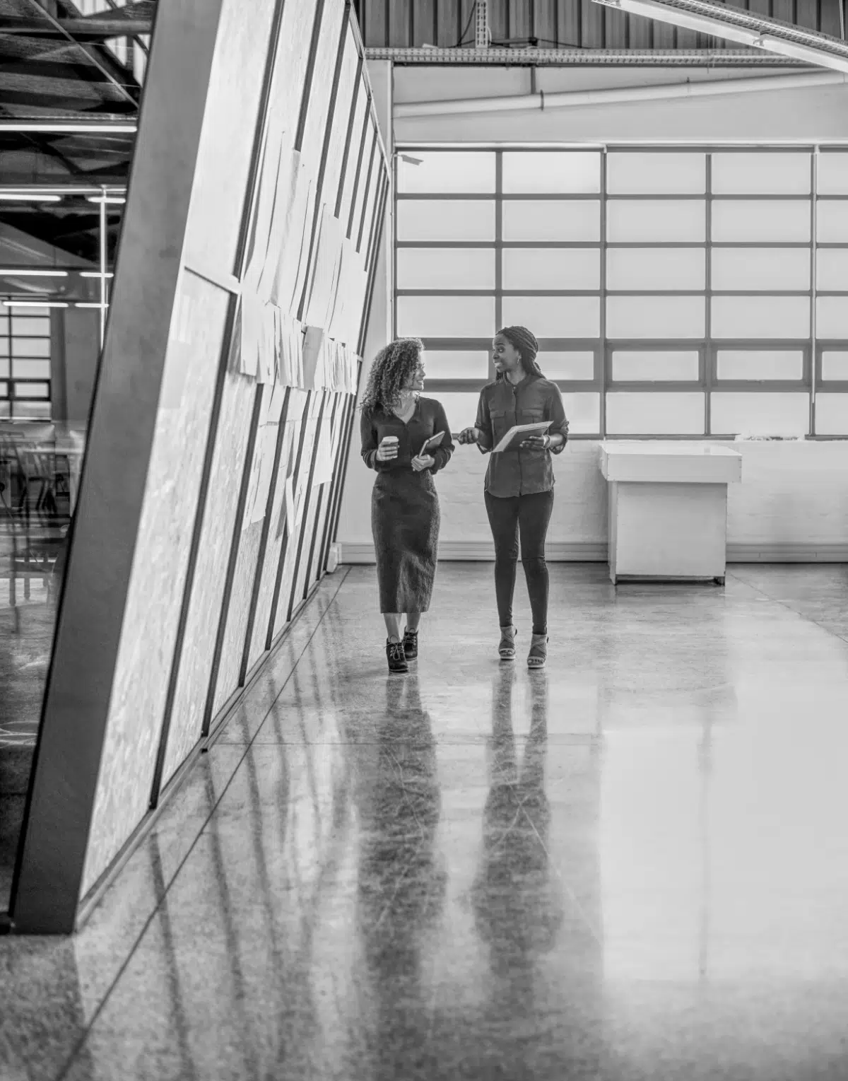 shot-of-two-businesswomen-having-a-discussion-whil-2025-04-06-09-57-33-utc